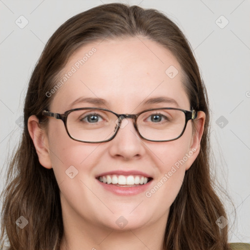 Joyful white young-adult female with long  brown hair and blue eyes