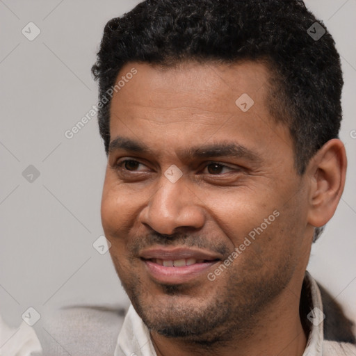 Joyful latino adult male with short  black hair and brown eyes