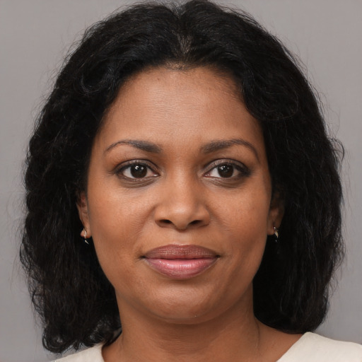Joyful black young-adult female with medium  brown hair and brown eyes