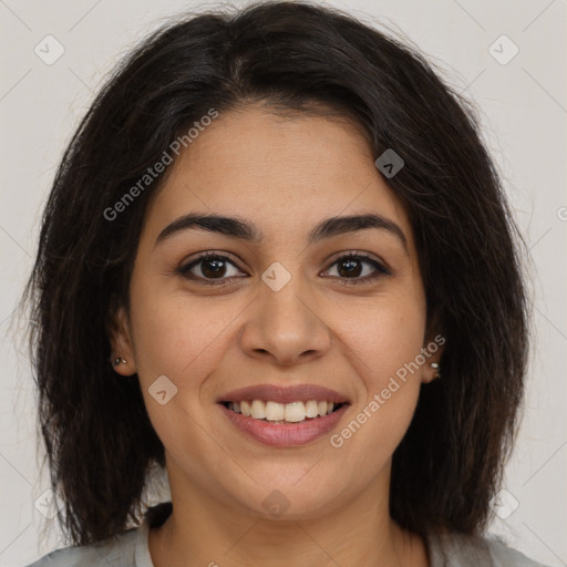 Joyful latino young-adult female with medium  brown hair and brown eyes