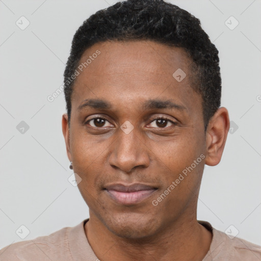 Joyful black young-adult male with short  black hair and brown eyes