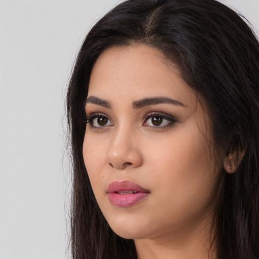 Neutral latino young-adult female with long  brown hair and brown eyes