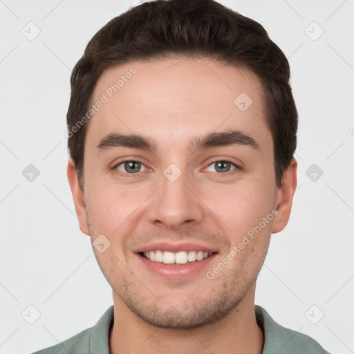 Joyful white young-adult male with short  brown hair and grey eyes