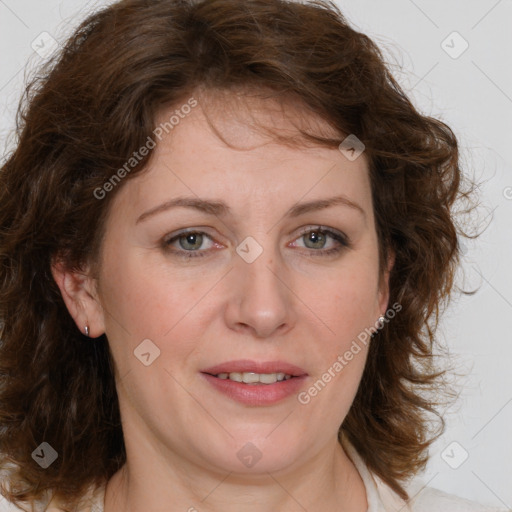 Joyful white adult female with medium  brown hair and green eyes