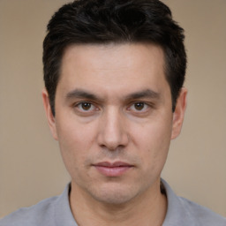 Neutral white young-adult male with short  black hair and brown eyes