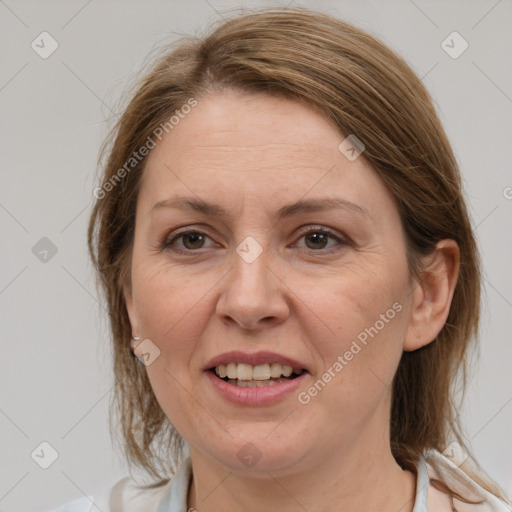 Joyful white adult female with medium  brown hair and grey eyes