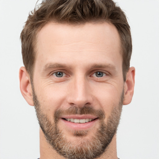 Joyful white young-adult male with short  brown hair and brown eyes