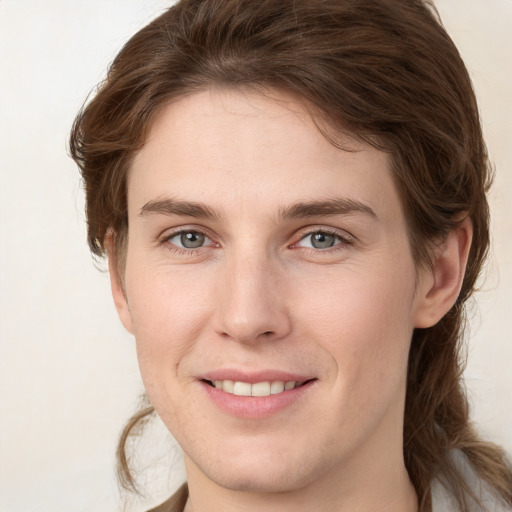 Joyful white young-adult female with medium  brown hair and green eyes