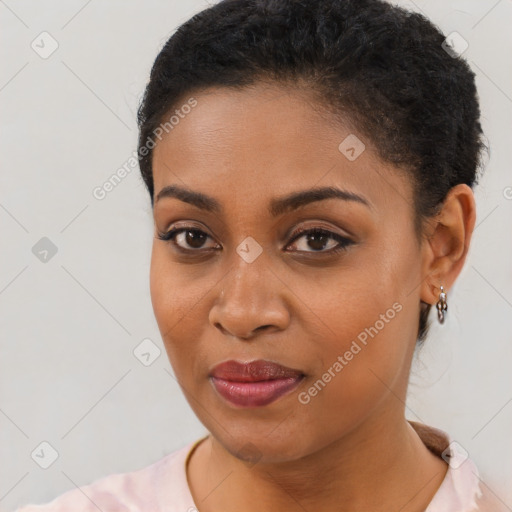 Joyful black young-adult female with short  brown hair and brown eyes