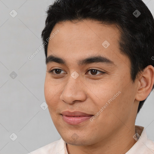 Joyful asian young-adult male with short  black hair and brown eyes