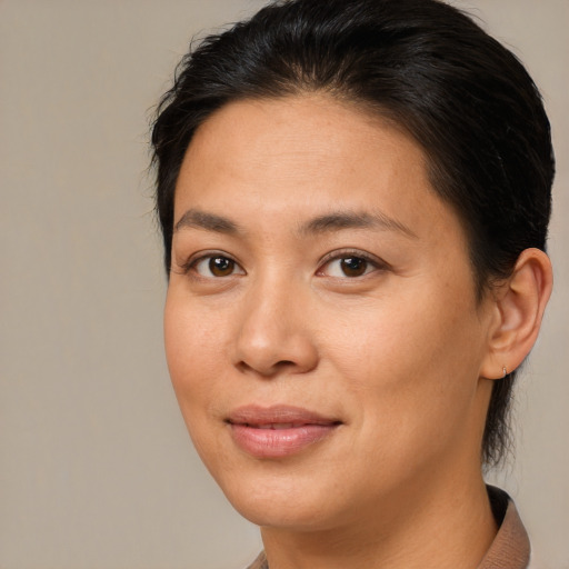 Joyful asian young-adult female with medium  brown hair and brown eyes
