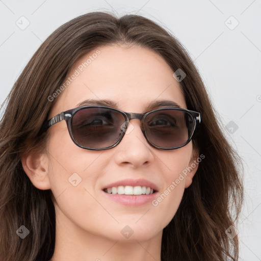 Joyful white young-adult female with long  brown hair and blue eyes