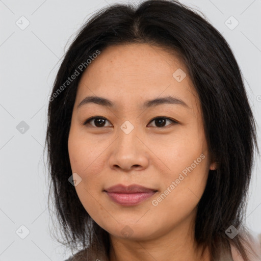 Joyful asian young-adult female with long  brown hair and brown eyes