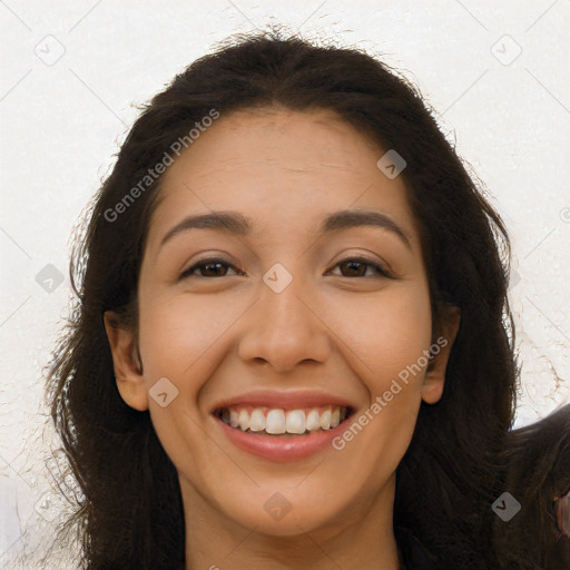 Joyful latino young-adult female with long  brown hair and brown eyes