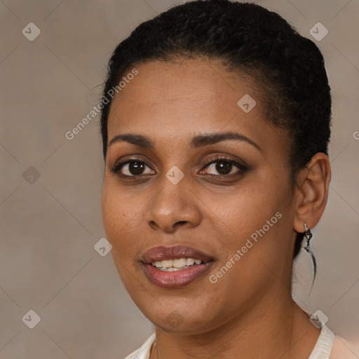 Joyful black young-adult female with short  brown hair and brown eyes