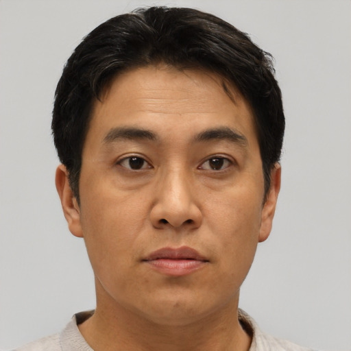 Neutral asian adult male with short  brown hair and brown eyes