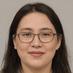 Joyful white adult female with long  brown hair and brown eyes