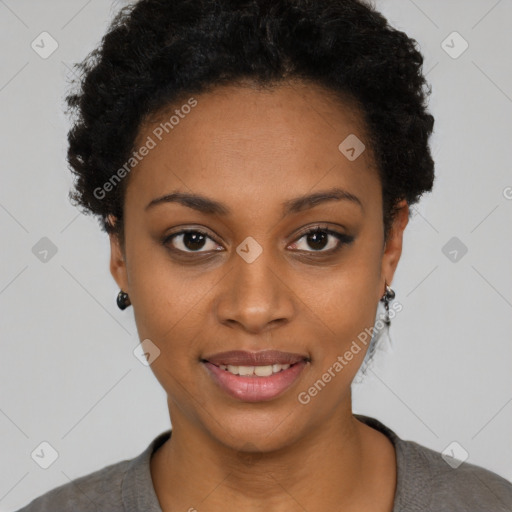 Joyful black young-adult female with short  black hair and brown eyes