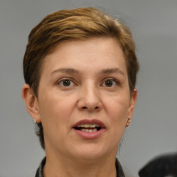 Joyful white adult female with short  brown hair and brown eyes