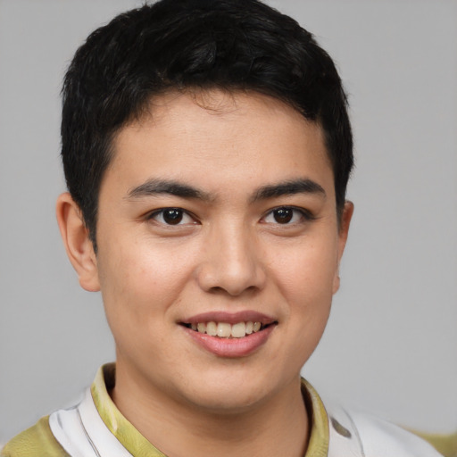Joyful latino young-adult male with short  brown hair and brown eyes