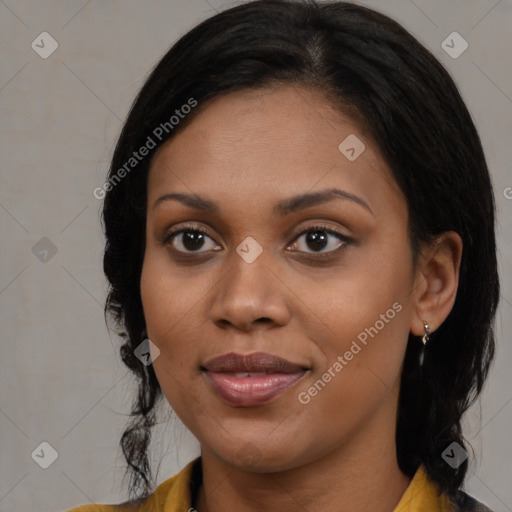 Joyful black young-adult female with long  brown hair and brown eyes