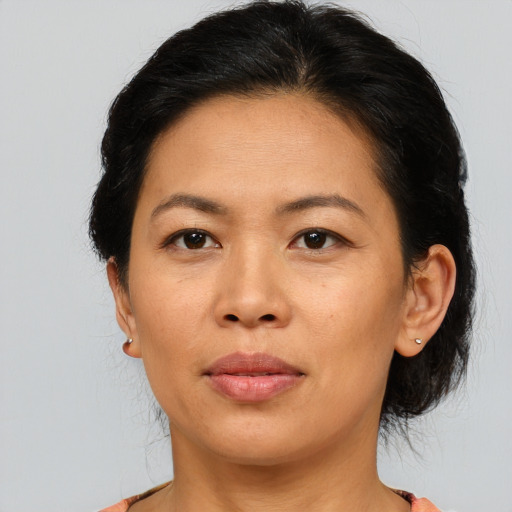 Joyful asian adult female with medium  brown hair and brown eyes