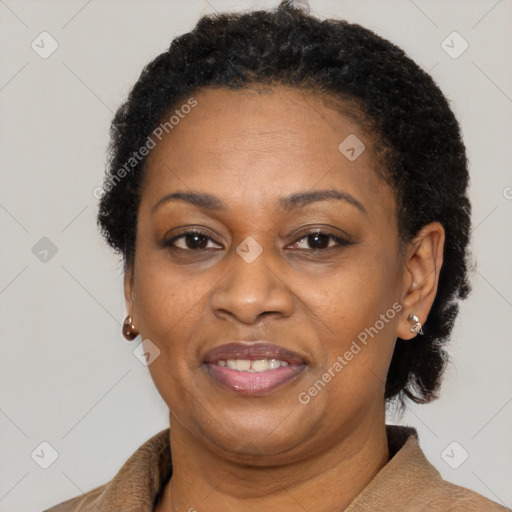 Joyful black adult female with short  brown hair and brown eyes