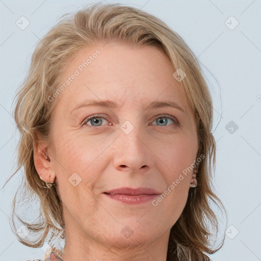 Joyful white adult female with medium  brown hair and blue eyes