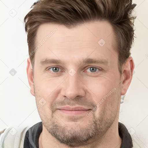 Joyful white adult male with short  brown hair and grey eyes