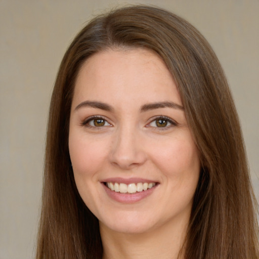 Joyful white young-adult female with long  brown hair and brown eyes