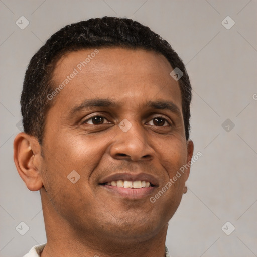 Joyful black young-adult male with short  brown hair and brown eyes
