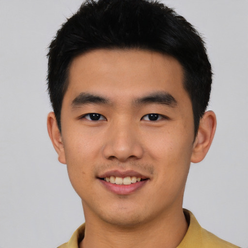 Joyful asian young-adult male with short  black hair and brown eyes