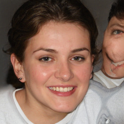 Joyful white young-adult female with short  brown hair and blue eyes