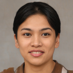 Joyful asian young-adult female with short  black hair and brown eyes