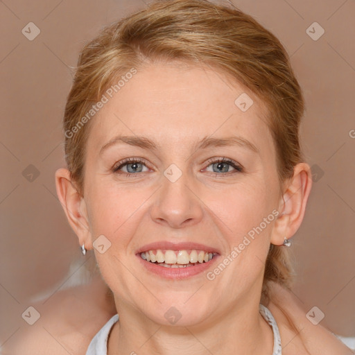 Joyful white young-adult female with medium  brown hair and blue eyes