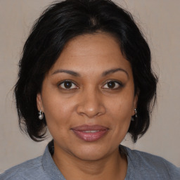 Joyful black adult female with medium  brown hair and brown eyes