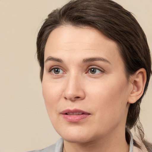 Joyful white young-adult female with medium  brown hair and brown eyes