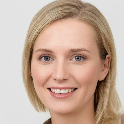 Joyful white young-adult female with medium  brown hair and blue eyes