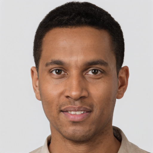 Joyful black young-adult male with short  brown hair and brown eyes