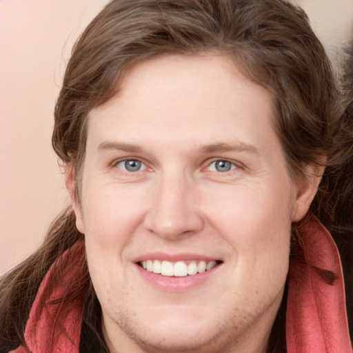 Joyful white young-adult female with long  brown hair and blue eyes