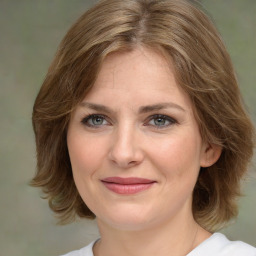 Joyful white young-adult female with medium  brown hair and green eyes