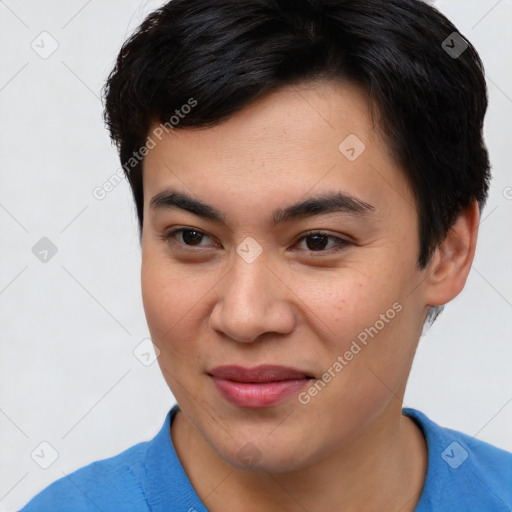 Joyful asian young-adult male with short  brown hair and brown eyes