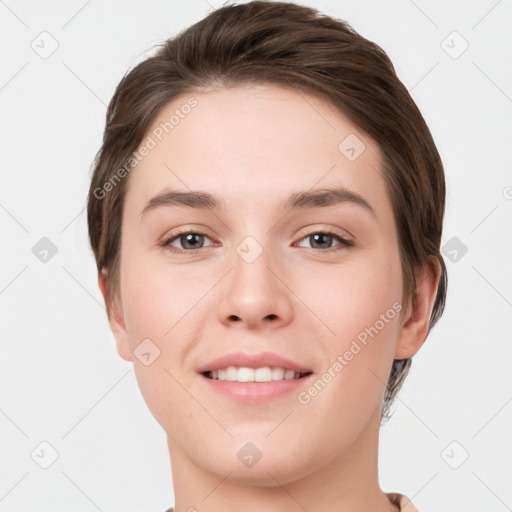 Joyful white young-adult female with short  brown hair and grey eyes