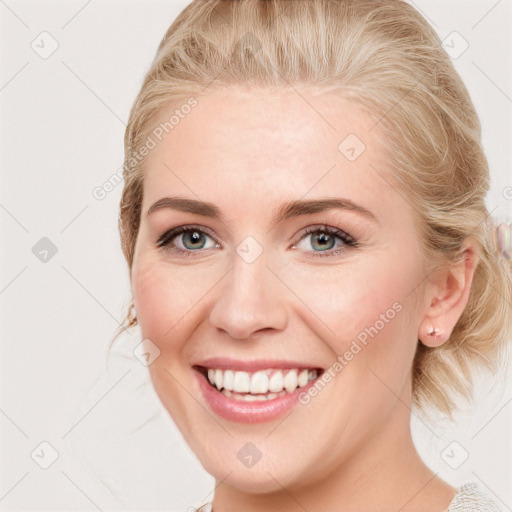 Joyful white young-adult female with medium  brown hair and blue eyes