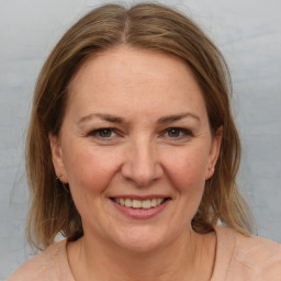 Joyful white adult female with medium  brown hair and brown eyes