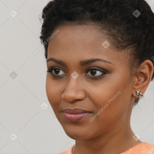 Joyful black young-adult female with short  brown hair and brown eyes