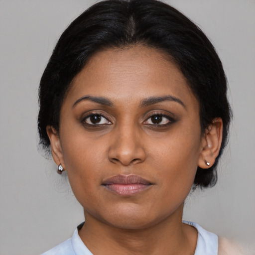 Joyful black young-adult female with medium  brown hair and brown eyes