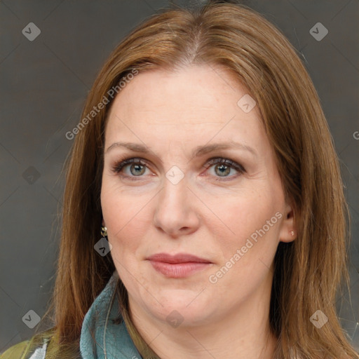 Joyful white adult female with long  brown hair and brown eyes