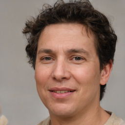 Joyful white adult male with medium  brown hair and brown eyes