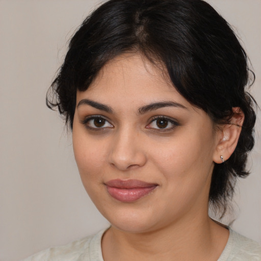 Joyful latino young-adult female with medium  black hair and brown eyes